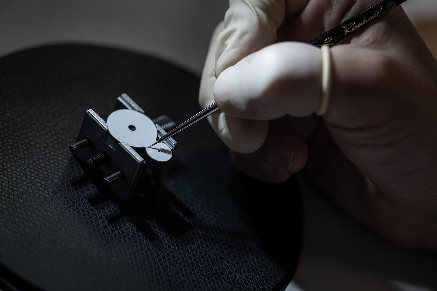 White enamel being applied by a fine paint brush