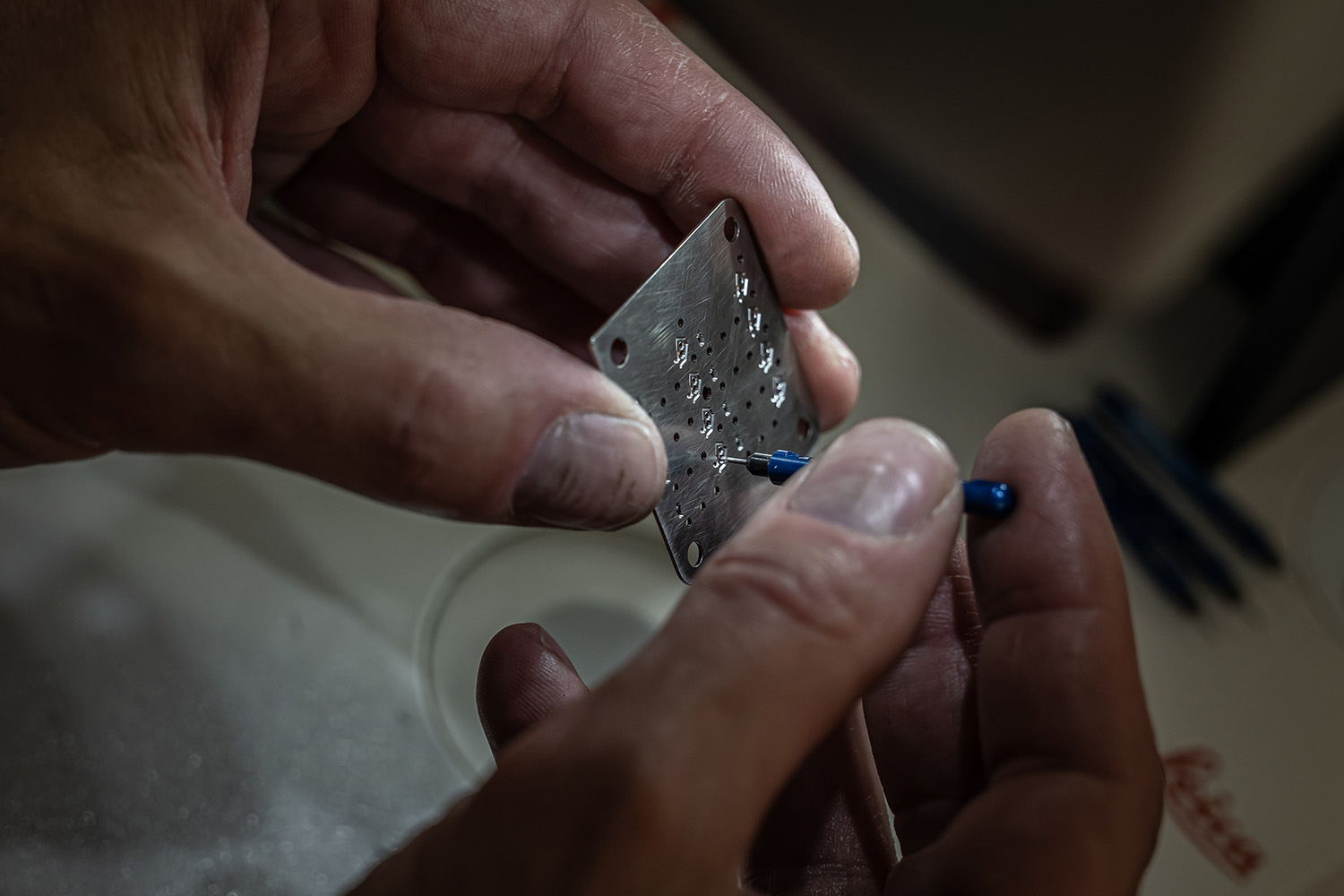 Holes being opened by hand with a pin